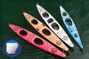 four colorful fiberglass kayaks - with Arkansas icon