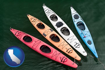 four colorful fiberglass kayaks - with California icon