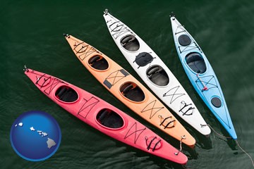 four colorful fiberglass kayaks - with Hawaii icon