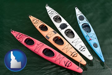 four colorful fiberglass kayaks - with Idaho icon