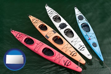 four colorful fiberglass kayaks - with Kansas icon