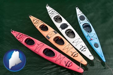 four colorful fiberglass kayaks - with Maine icon