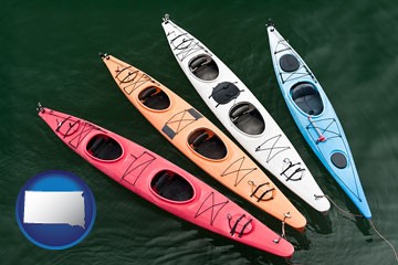 four colorful fiberglass kayaks - with South Dakota icon